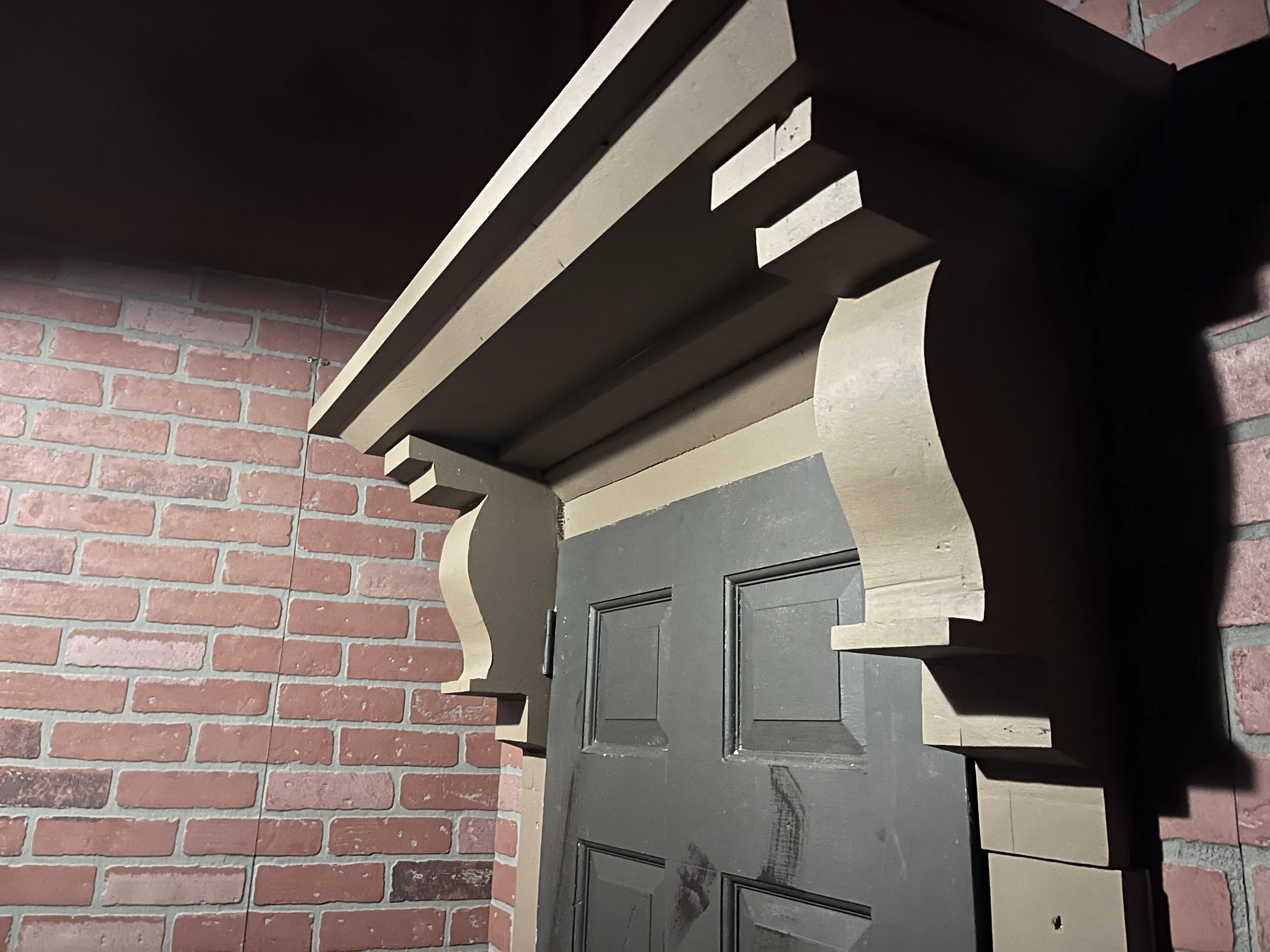 Close-up of the carved foam mantelpiece over the door