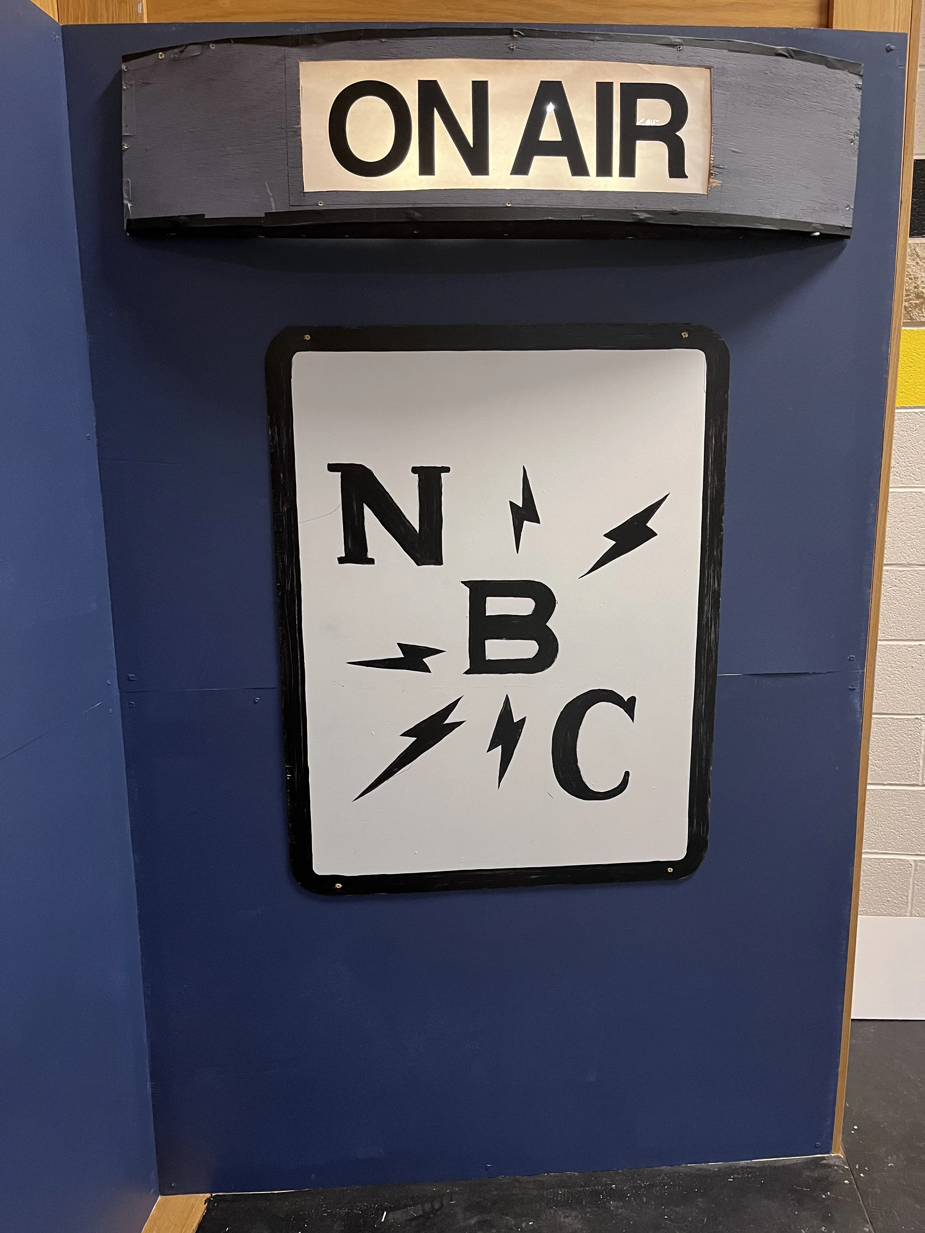 The NBC sign and ON AIR sign mounted on the studio flat