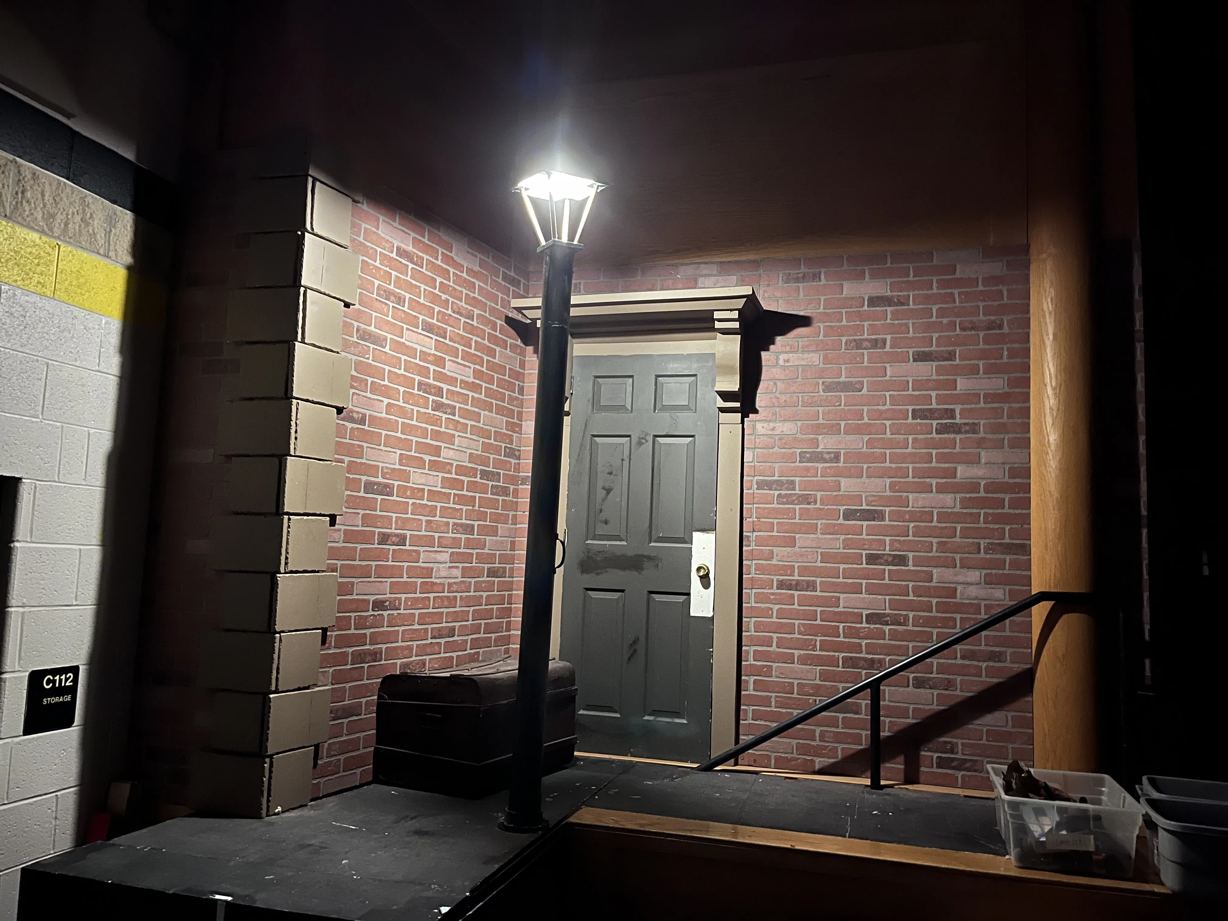 The NYC street scene with brick wall, door, and street lamp