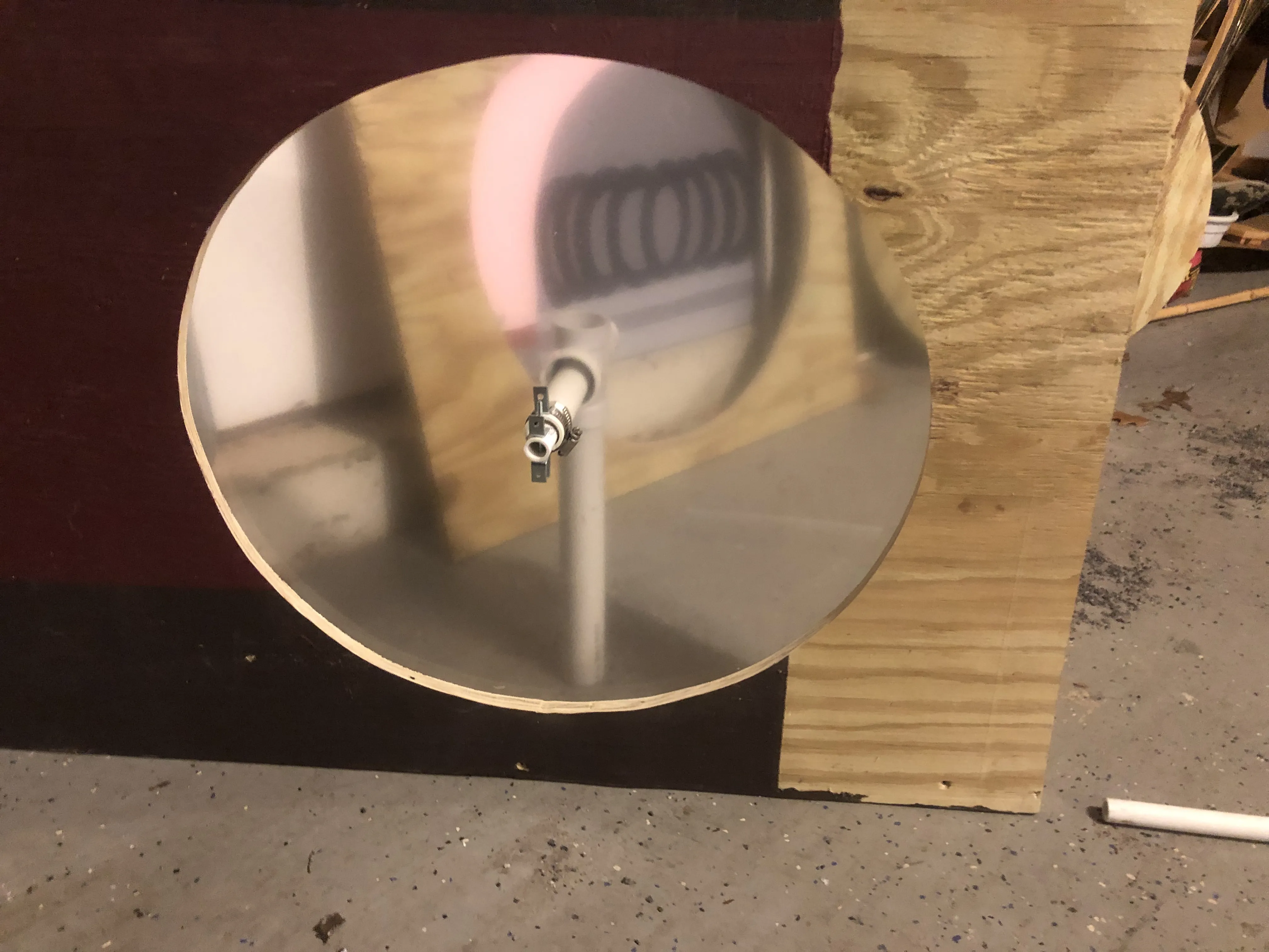 The plexiglass clock face in its wooden frame, built in the garage