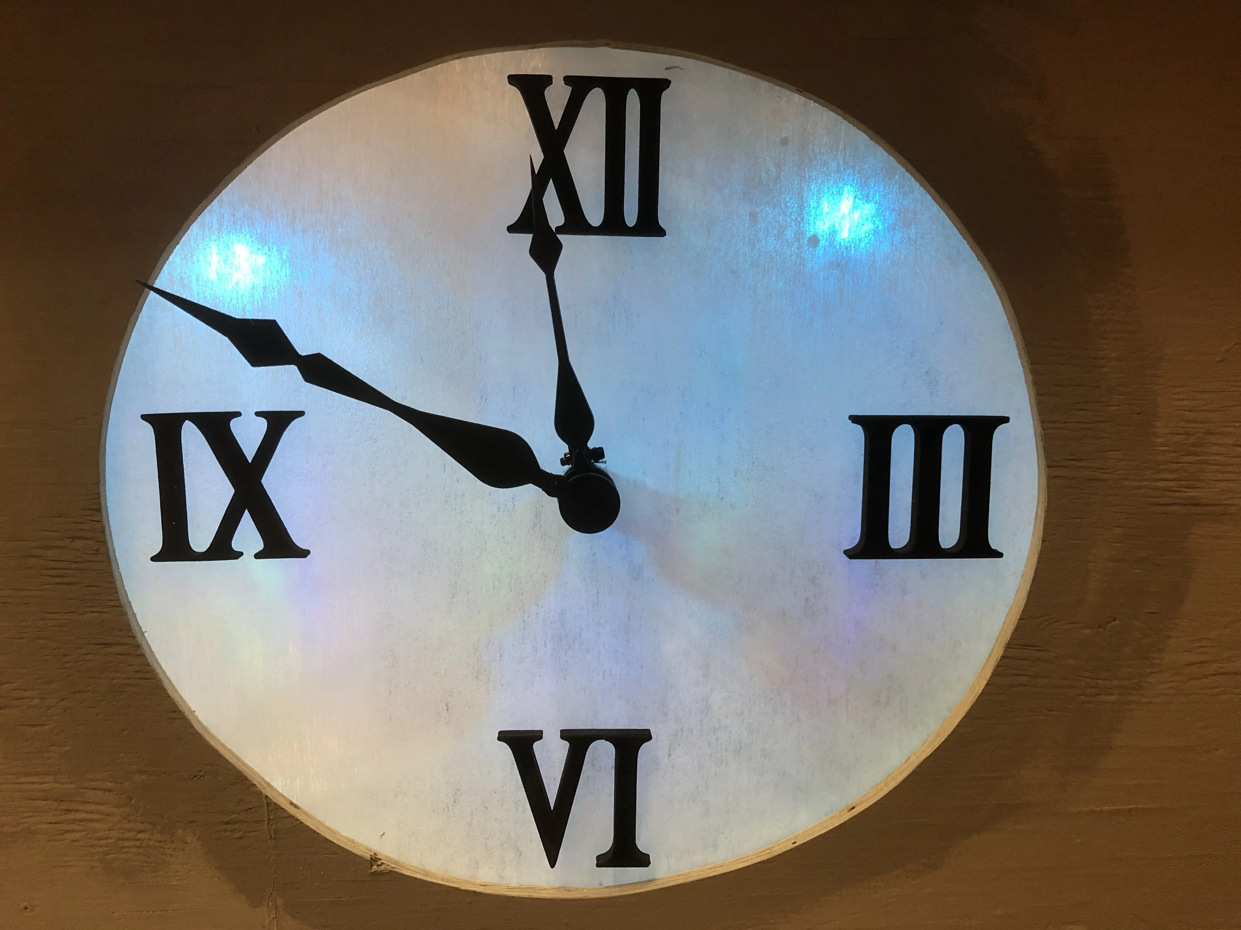 The finished clock box — roman numerals applied, terracotta roof tiles, both hands installed