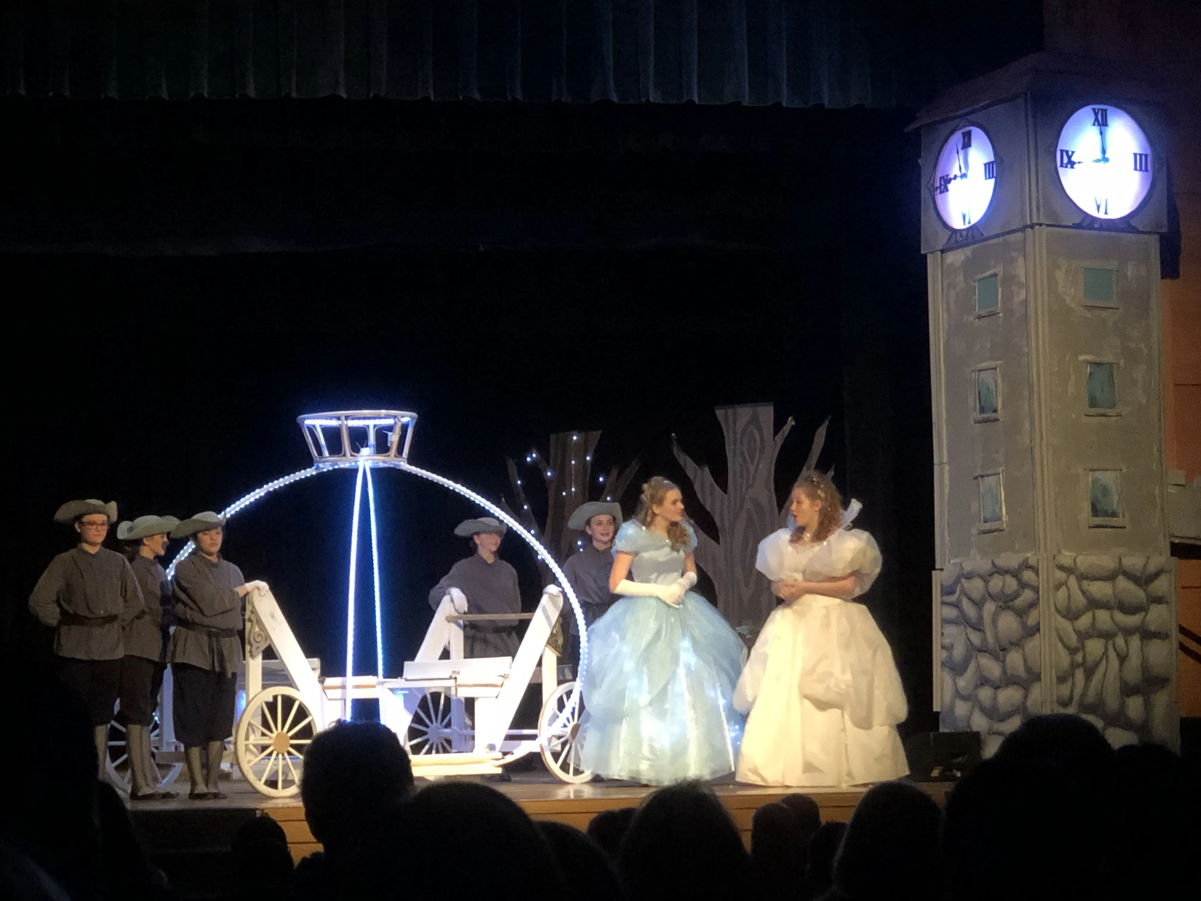 The ball scene — Cinderella, the Fairy Godmother, the lit carriage, and the glowing clock at midnight