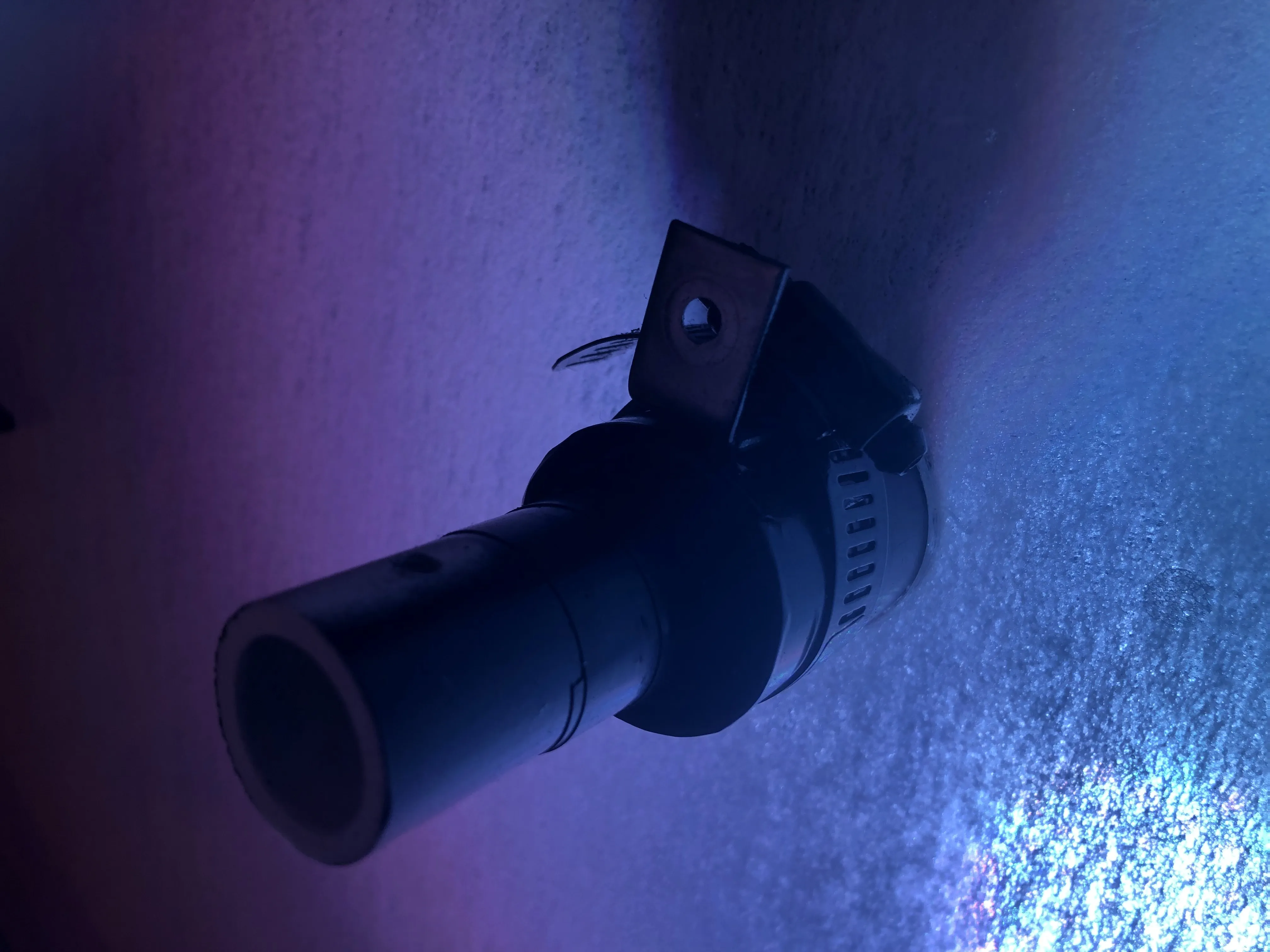 The PVC pivot hub glowing purple-blue from the internal PAR lighting during the show