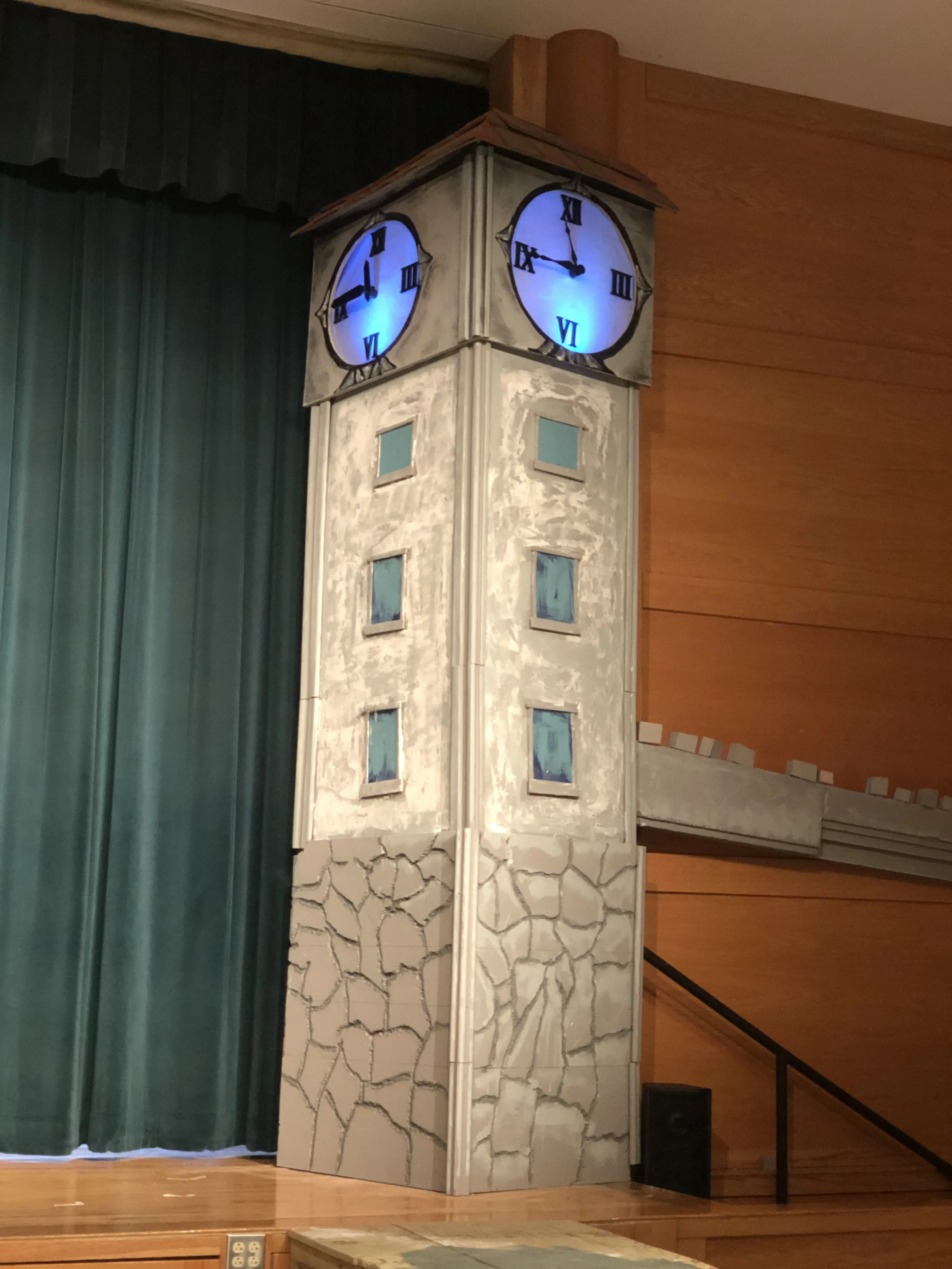 The finished tower fully lit — both clock faces glowing blue