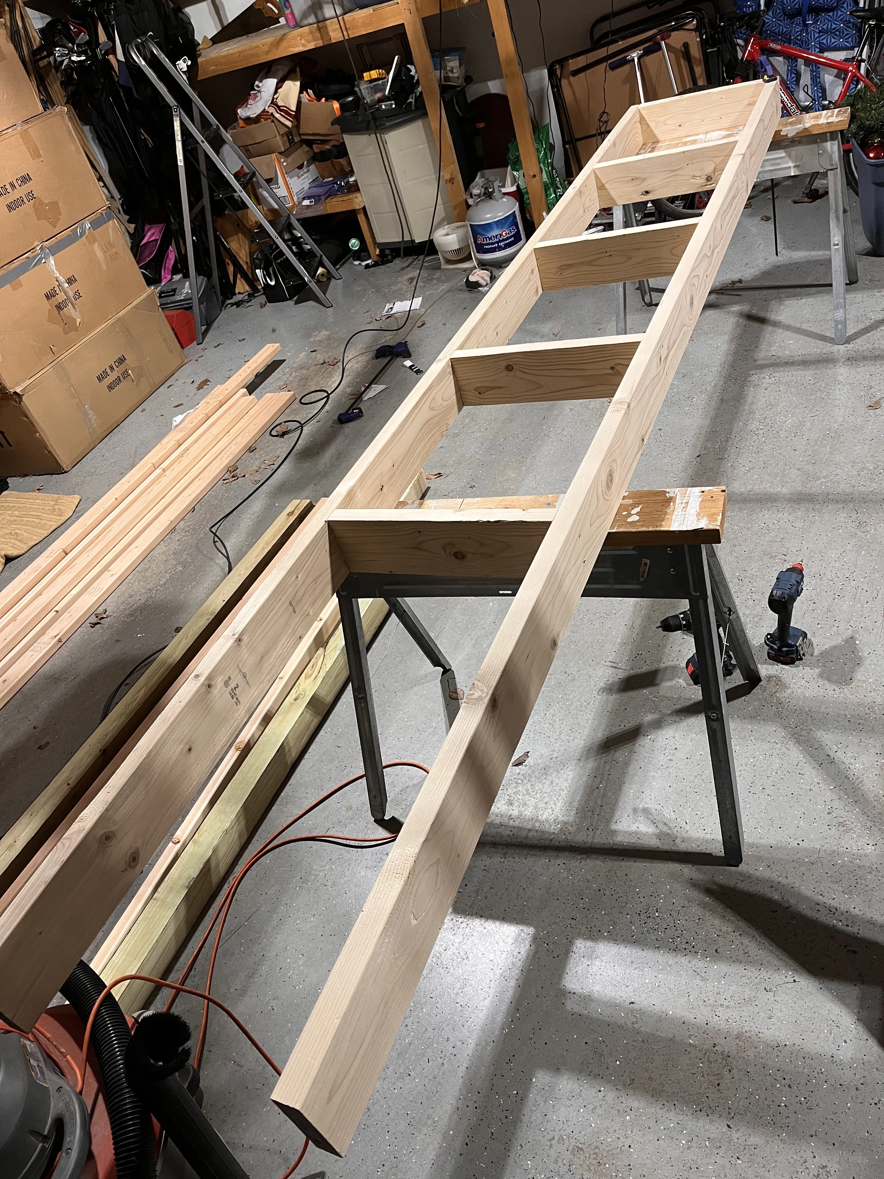 Building the seesaw arm in the garage — the laminated 2x10 I-beam construction