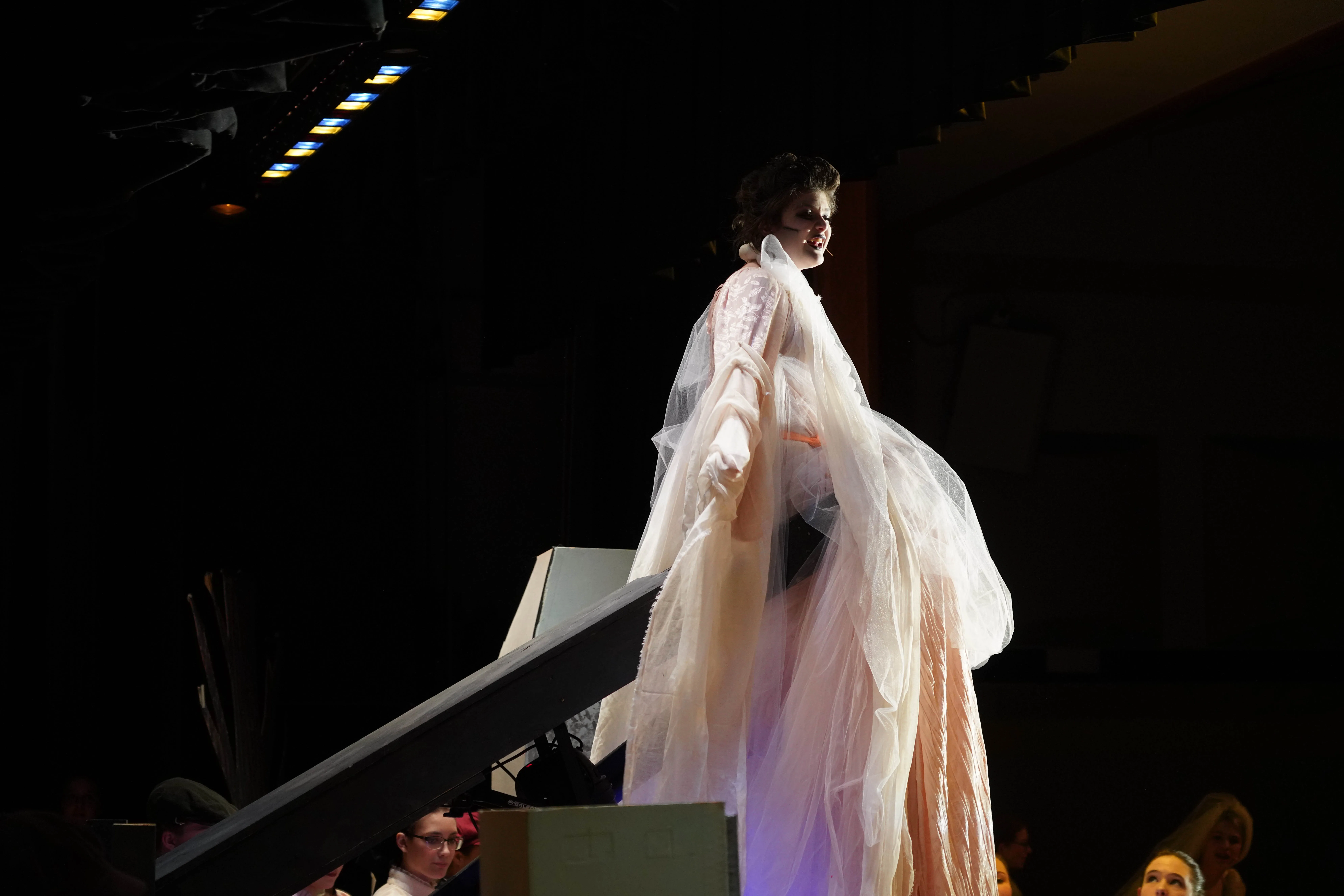 Fruma-Sarah rising over the audience with the cast reacting below