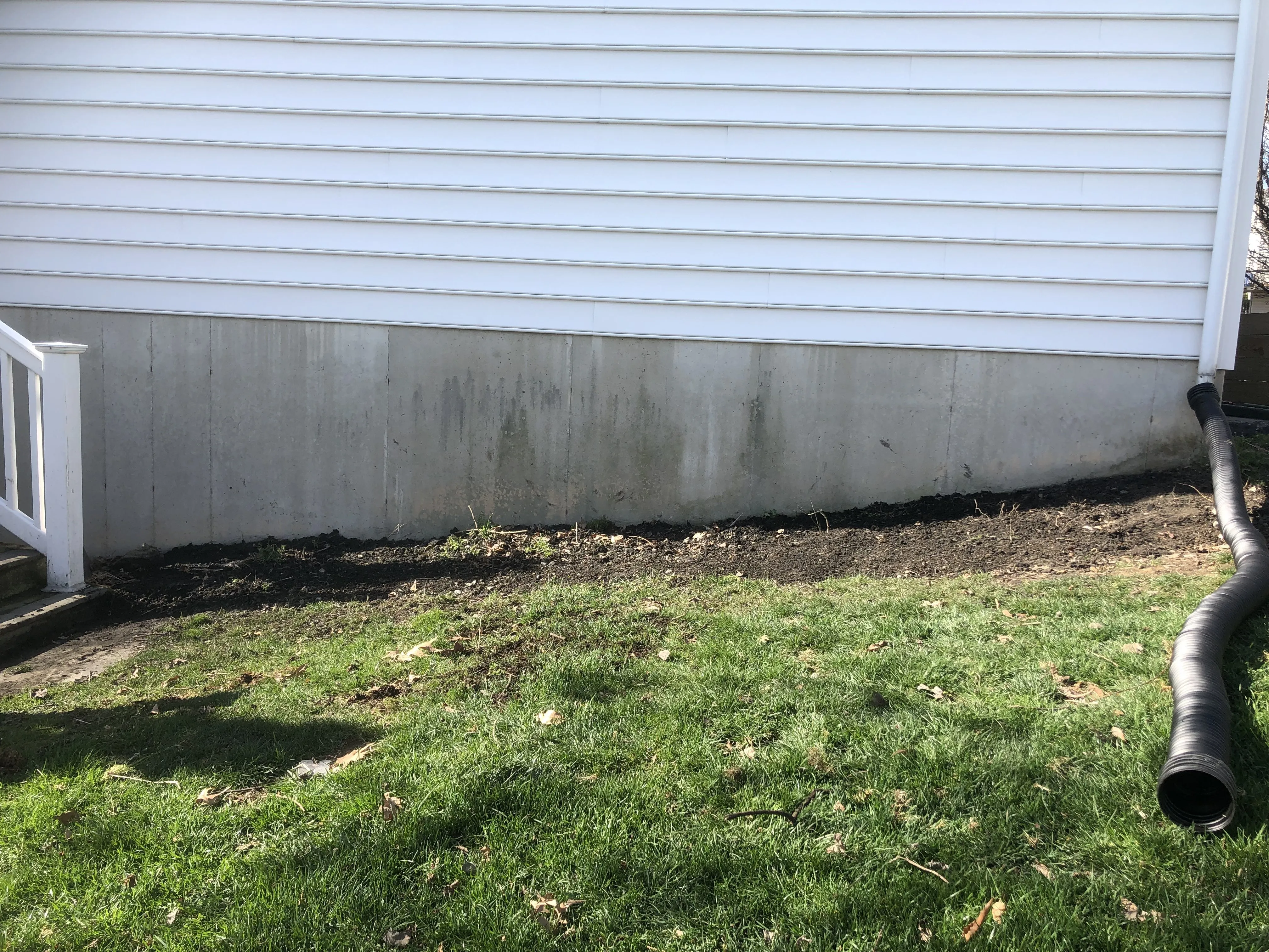 The bare ground along the house foundation before the build