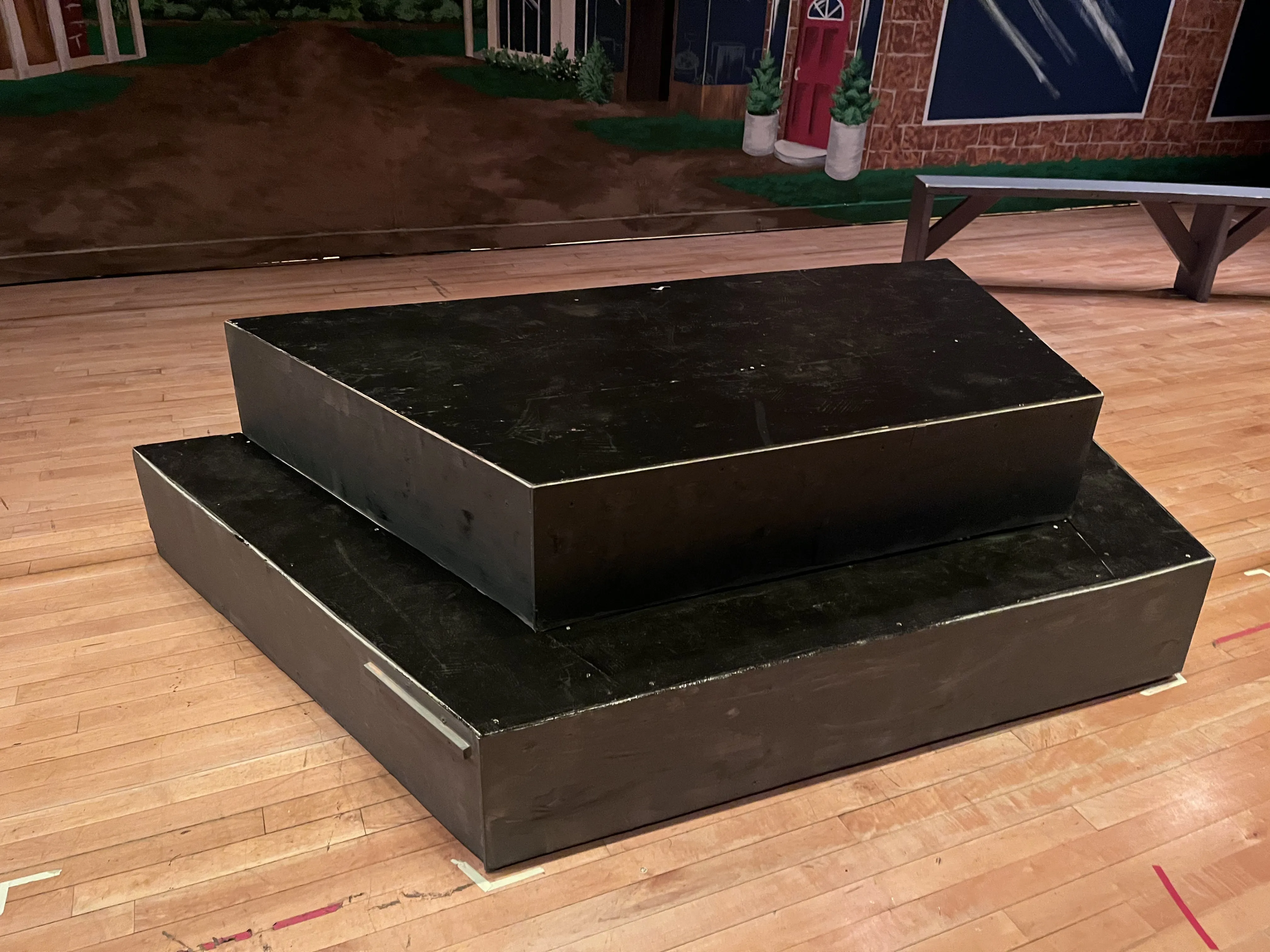 The two-tier platform in front of the River City backdrop — simple stacked boxes, ready for the show